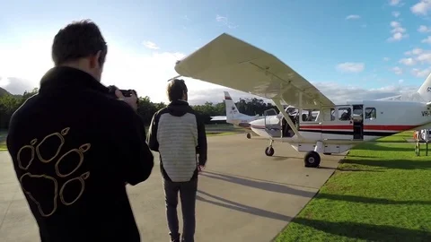 Male walking torwards small engine air plane Stock Footage 71443148