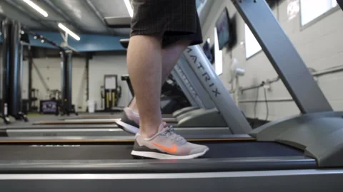 Male Walking on Treadmill - side- medium Video stock 253195020