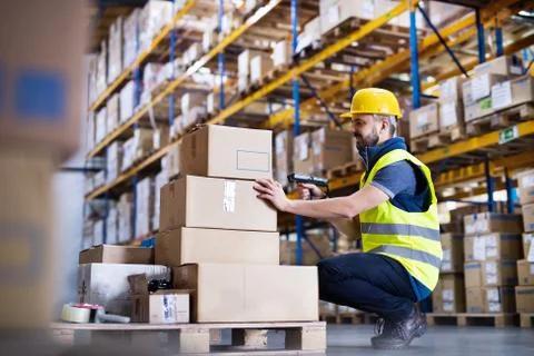 Male warehouse worker with barcode scanner. Stock Photos