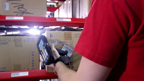 Male warehouse worker scans barcode and transfers goods Stock Footage 238767424