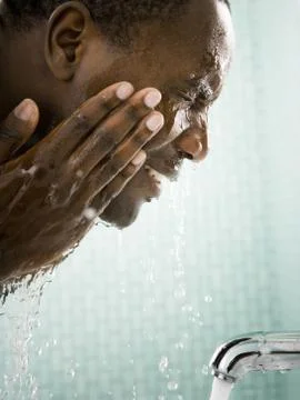 Male washing his face Stock Photos