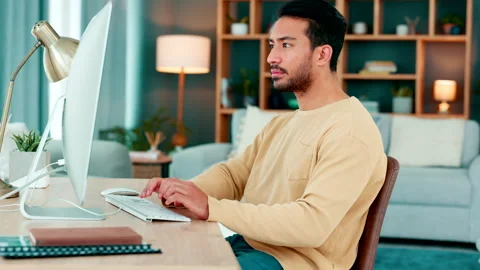 Male web designer developing and writing code for an internet website while Stock Footage 254928363