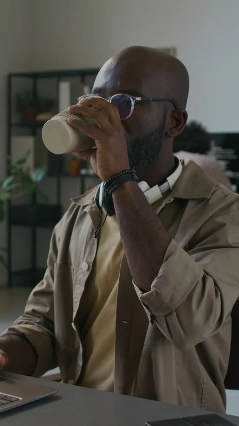 Male Web Engineer Drinking Coffee from Reusable Cup while Working on Laptop Stock Footage 299206614