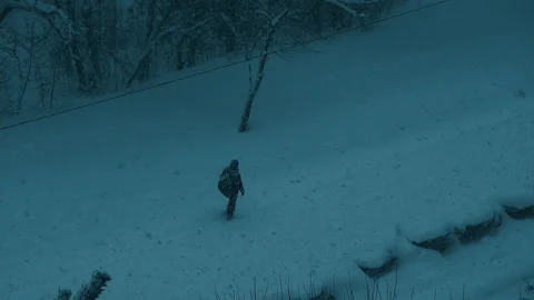 Male work. Help. Man walk through heavy snowfall at night Stock Footage 150674817