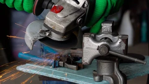 Male worker with angular grinding machine is cutting the metal. Slow motion Stock Footage 78423984
