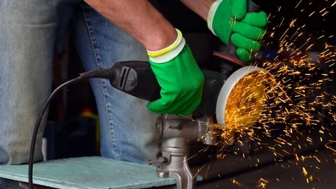 Male worker with angular grinding machine is cutting the metal Stock Footage 78424031