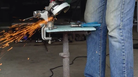 Male worker with angular grinding machine is cutting the metal. Slow motion Stock Footage 78992380
