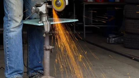 Male worker with angular grinding machine is cutting the metal Stock Footage 78992393