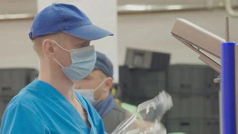 Male Worker Attaching Empty Plastic Milk Bottles To A Conveyor Machinery Video stock 162394859