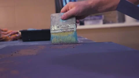 Male worker creates texture on the surface with a brush and paints Stock Footage 156512292