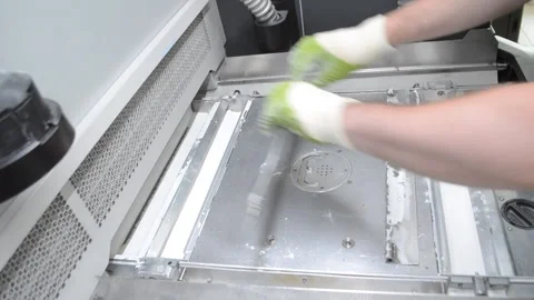 Male worker disassembles and removes details inside large industrial 3D printer Stock Footage 191614338