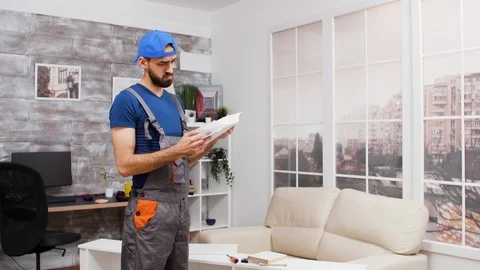 Male worker getting confused while reading instruction Stock Footage 123356673