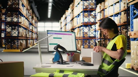 Male worker managing package labeling using shipment details adhesive tags Stock Footage 313088757