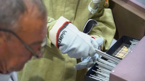 Male worker opens box, takes out container with a lot of welding electrodes. Stock Footage 126356016