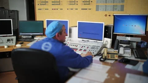 A Male worker is Operating the control hub inside of the Power engineering Room Stock Footage 276319832