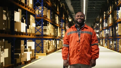 Male worker organizing packages in fulfillment center storage room Stock Footage 332906895