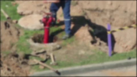 Male worker performs sewerage work in a sewer well with a hydrant. Sewer and Video stock 317090257