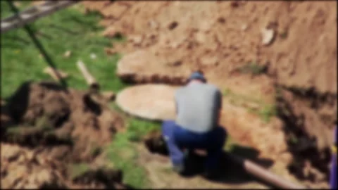 Male worker performs sewerage work in a sewer well with a hydrant. Sewer and Stock Footage 317807957