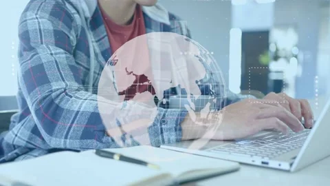 Male worker placing hands on keyboard and typing at desk, tech globe overlay Stock Footage 335282974
