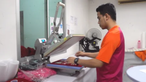  male worker on Pressing The Transfer Element On A T-Shirt Stock Footage 106791801