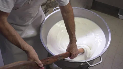 Male worker string mozzarella cheese in factory during process  - slow Stock Footage 202063781
