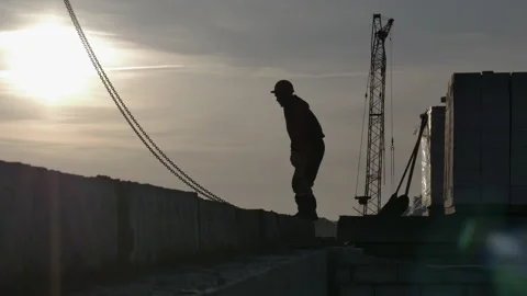 Male worker in a sunset on a construction site Stock Footage 248289734