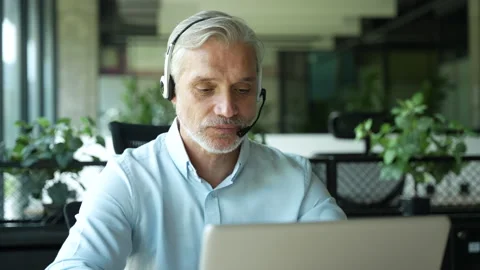 Male worker talking with headset, helping and consulting Stock Footage 295185784