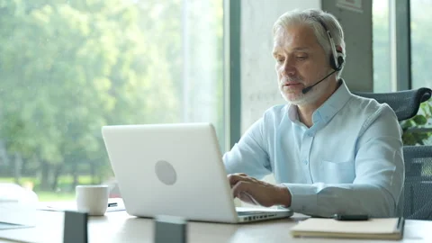 Male worker talking with headset, helping and consulting Stock Footage 295186320