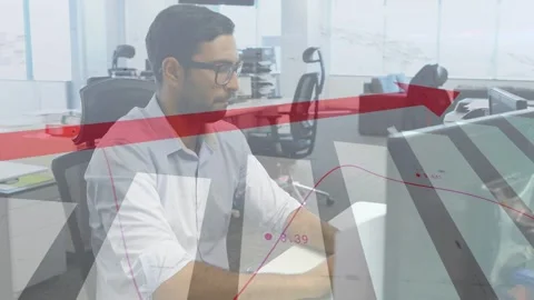 Male worker typing at desk while red arrow, wavy data line moving over monitor, Stock Footage 334694379