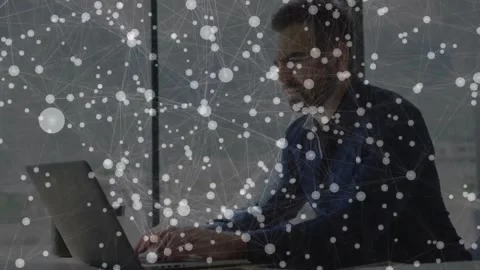 Male worker typing on laptop for work, typing initiating tech network overlay Stock Footage 330959641
