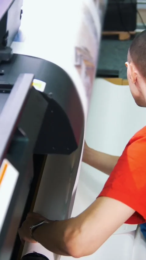 Male worker in typography corrects the material for the printing press Stock Footage 346706477