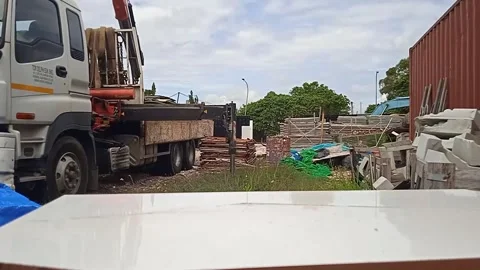 Male Worker Unloading Material Using Crane Truck and Moving Clouds Stock Footage 305771495