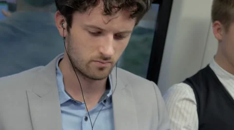 Male worker using an app on his cell phone in the train Stock Footage 67259700
