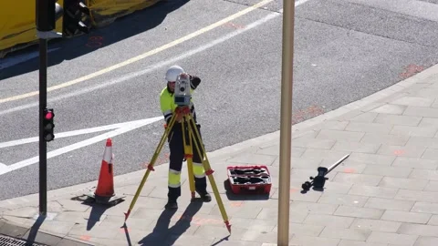 Male worker using a total station for road measurement Stock Footage 172543032
