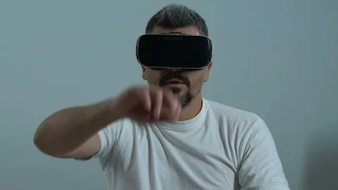 Male worker in vr headset scrolling screen, virtual training program, innovation Stock Footage 92029312