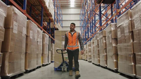 A male worker in the warehouse doing his job Stock Footage 264083871