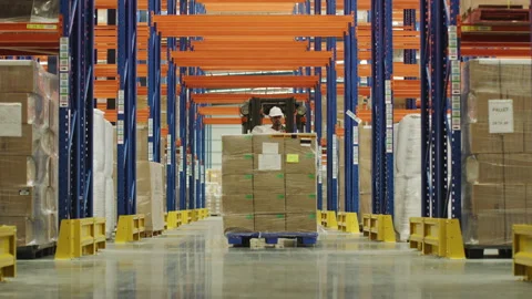 A male worker in the warehouse using a forklift to move products from one p.. Stock Footage 264081472