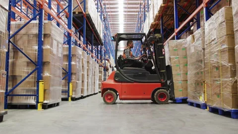 Male worker in the warehouse using a forklift Stock Footage 264083624