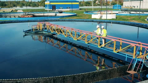 Male workers are observing processed wastewaters Stock Footage 142989528