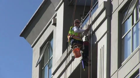 Male working with caution on top of high storey building Stock Footage 52259038