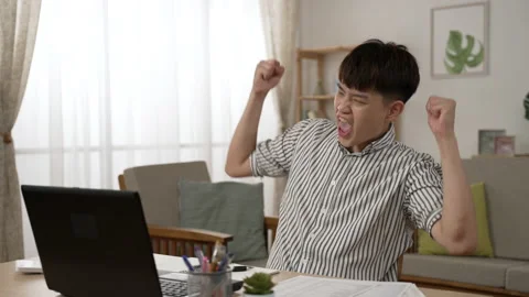 Male working from is cheering with clenched fists 動画素材 204792199
