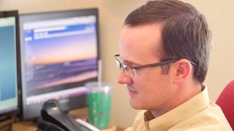 Male working on a computer in his office Stock Footage 52314348