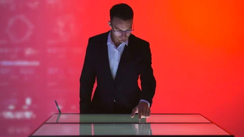 The male working with a touchscreen on the hologram background Stock Footage 100564512