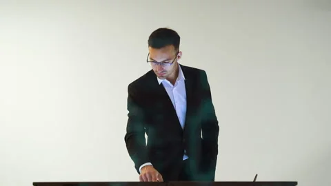 The male working with a touchscreen on the white background with a hologram Video stock 100564504