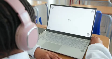 Male youth sitting at school using laptop with alignment marks, adjusting grip Stock Footage 340656305