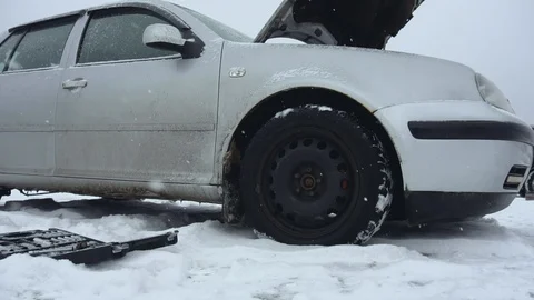 Malfunction or problem with broken car in winter snowfall. Hood or bonnet raised Stock Footage 121137557