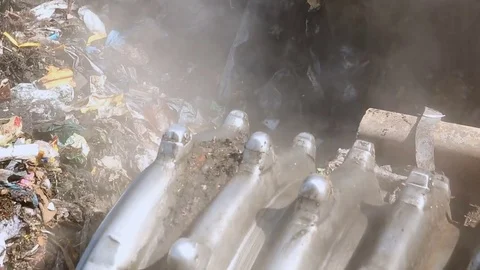 Malicious evaporation in the process of moving trash. Bulldozer working at the Stock Footage 76225137