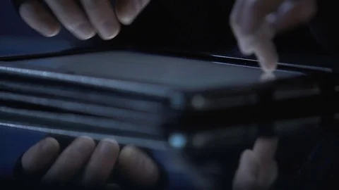 Malicious hacker attacks website from tablet pc, commits cyber extortion crime Stock Footage 71655744