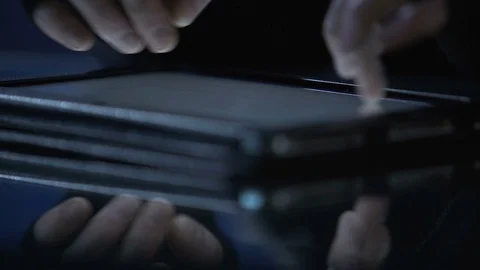 Malicious hacker attacks website from tablet pc, commits cyber extortion crime Stock Footage 71658662