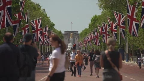 Mall aligned with Union Jack flags to Buckingham Palace, London, England Stock Footage 243079020